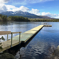 dock at camp natarswi with a view of mount katahdin