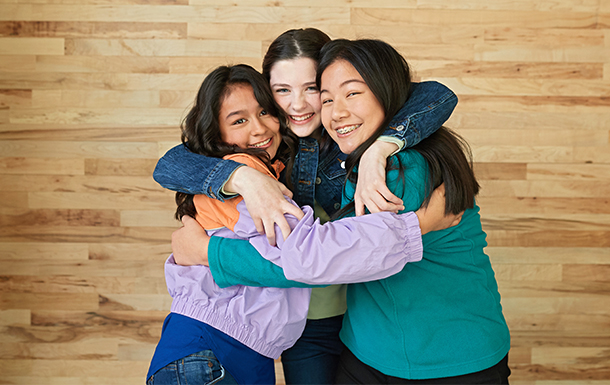 girl scouts hugging