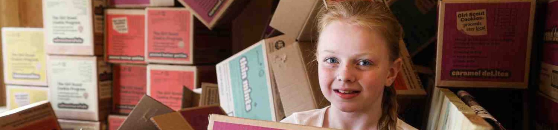  Liliana surrounded by cookie boxes 