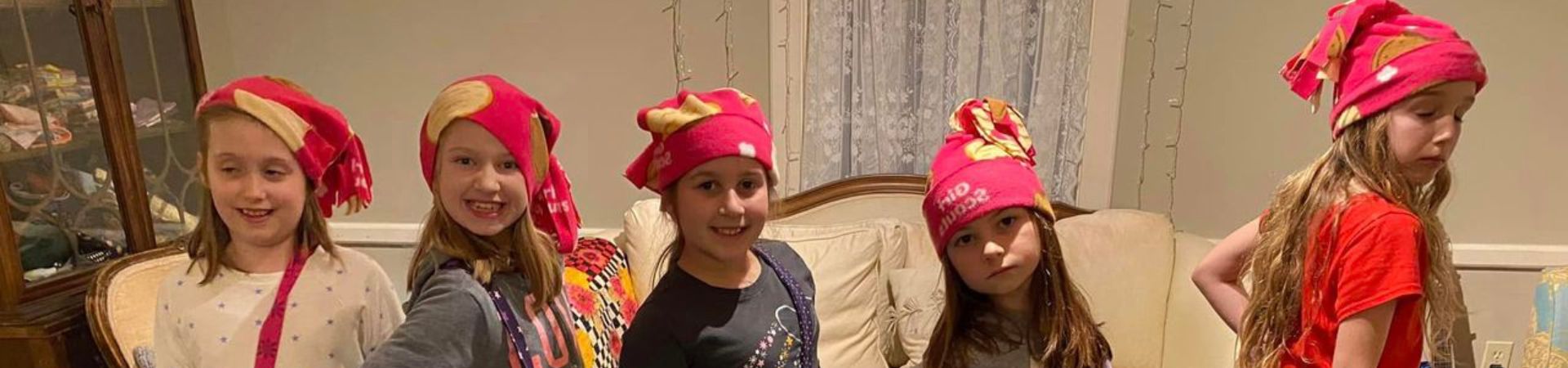  Five Girl Scouts wearing fleece hats that they sewed themselves 