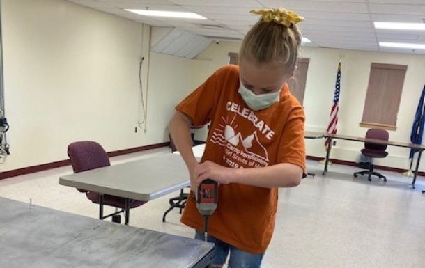 Girl Scout from troop 507 working to build a cart