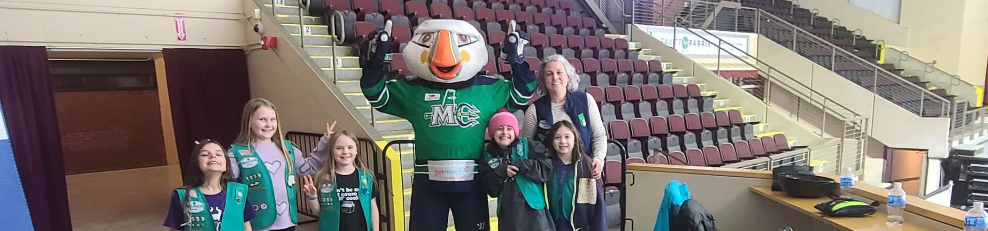  Girl Scouts with their troop leader and Beacon, the Maine Mariners mascot 