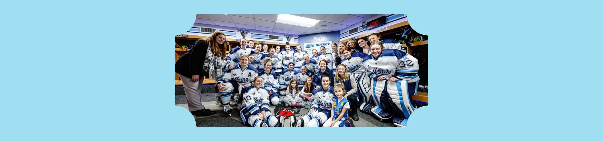  Three Girl Scouts surrounded by UMaine women's hockey team 