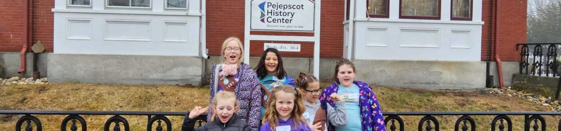  Six Girl Scouts standing in front of the Pejepscot History Center building 