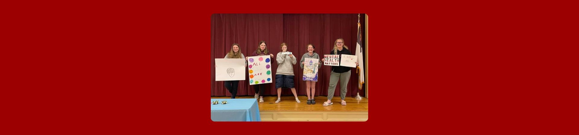  Four Girl Scouts holding up mental health awareness signs 