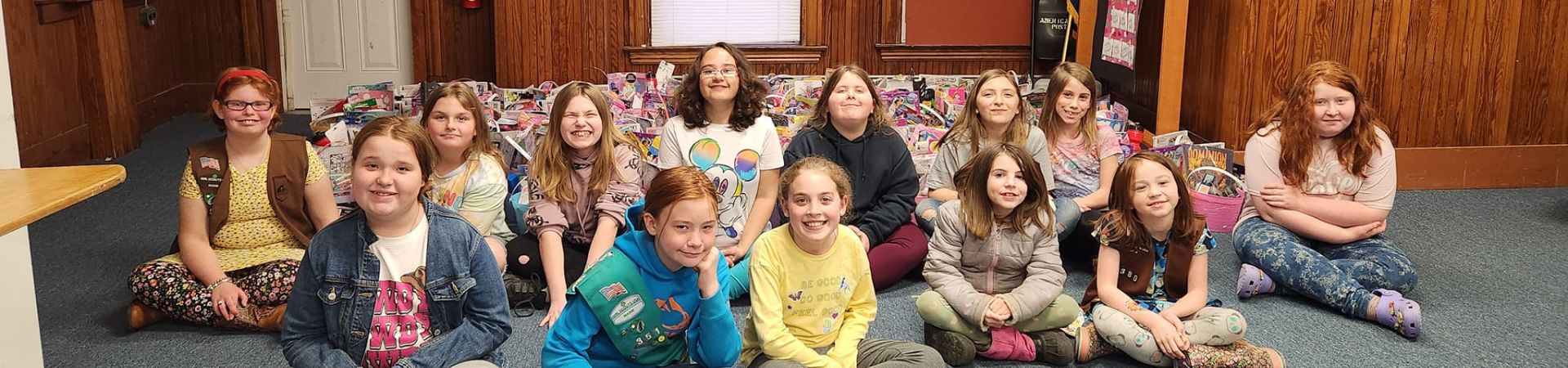  Girl Scouts from Troop 351 surrounded by the Easter baskets they put together 