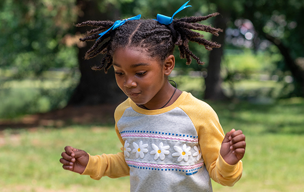 Excited girl wearing Girl Scout gear