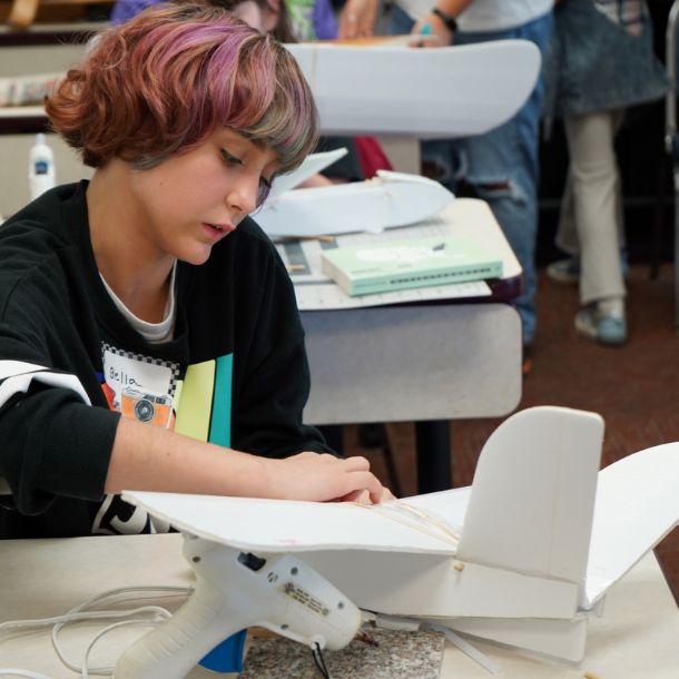 girl building model plane