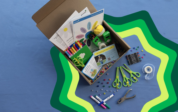 Girl Scout Experience Box open with all the contents in and around it