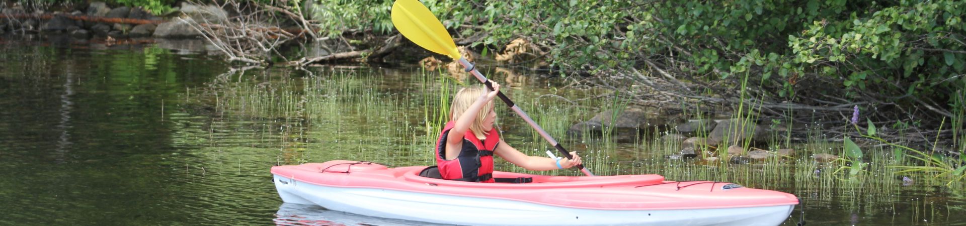  Girl in kayak on the lake 