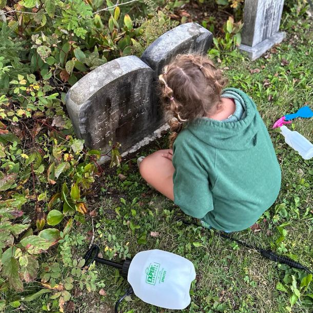 layla cleaning up a headstone