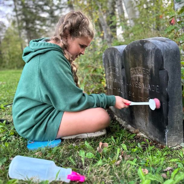 layla cleaning up a headstone
