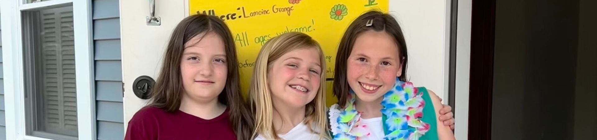  Three Girl Scouts standing in front of their talent show sign 