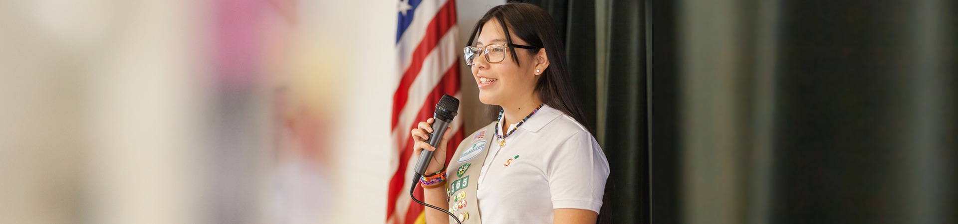  Older girl speaking into a micophone 