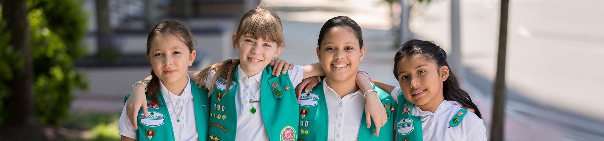  Group of Junior Girl Scouts wearing their vests with patches on display 